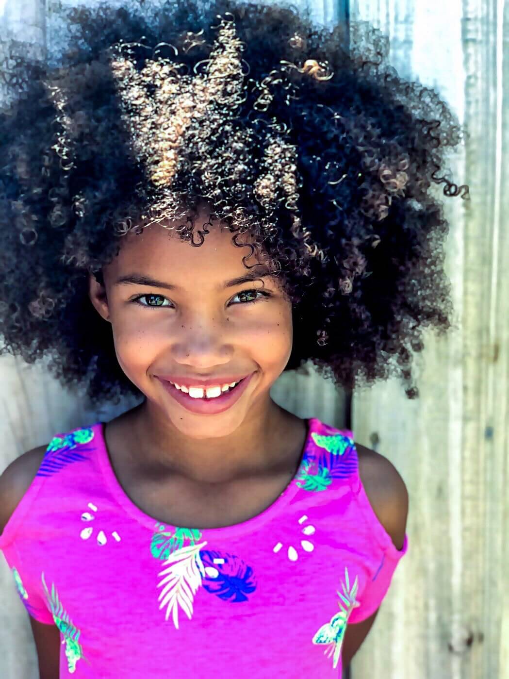 Smiling girl with curly hair